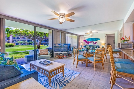 The open-concept living and dining area features large windows that bring in natural light and provide beautiful garden views.