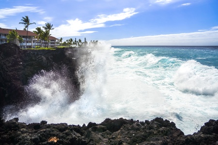 Be amazed with nature's beauty: ocean waves crashing against the rugged cliff.
