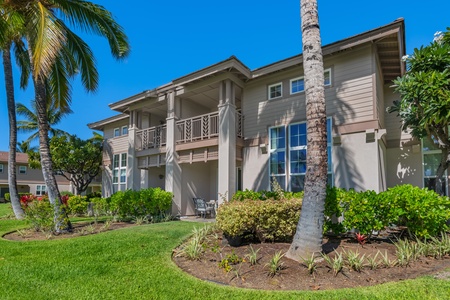 Beautiful villa exterior surrounded by swaying palms and sunny skies, capturing the essence of island living.