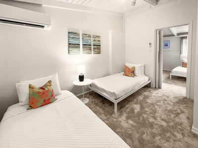 Secondary bedroom with a twin bed, accessed through the first bedroom.