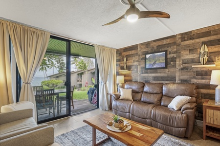 Recline with the lanai doors open and green just beyond the glass.