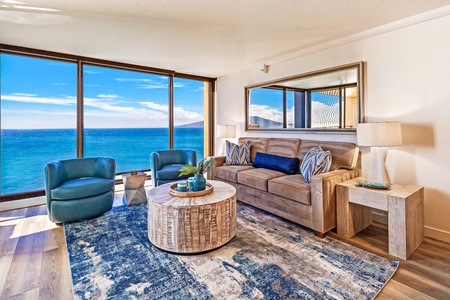 This bright and inviting living area features floor-to-ceiling windows with stunning ocean views.