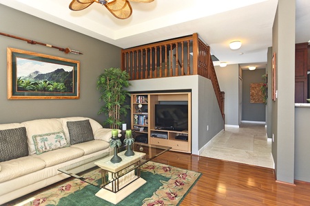 Sink into the plush seating in the living area surrounded by natural wood tones.