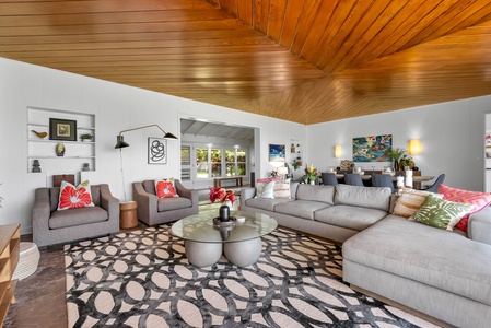 Stylish mid-century flair and cozy seating invite family conversations, board games, or relaxing after a day at Lanikai Beach.