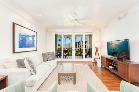 Unwind in your bright living room featuring plush seating and tropical views from your lanai..