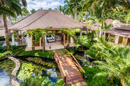 Walk across the bridge to your private tropical home.