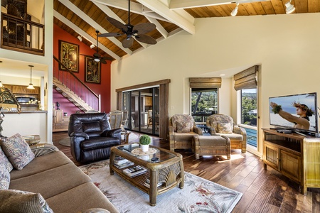 Comfortable Tropically appointed living room  with the stairs to the loft in the background