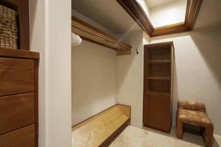 Your spacious walk-in closet features warm wood finishes, ample hanging space, and built-in storage for all your vacation wardrobe needs.