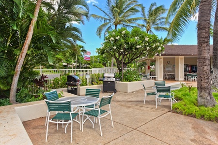 Relax at BBQ area surrounded by swaying palms and tropical blooms, perfect for memorable meals under Hawaii's blue skies.