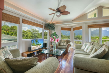 The bright and cozy living room has scenic views and plush seating.