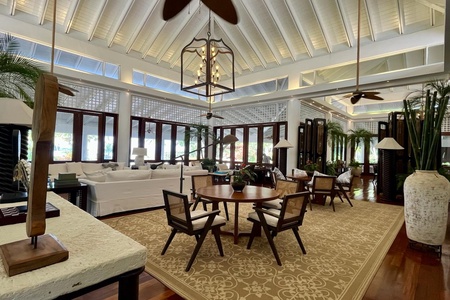 Open-concept living area with elegant furnishings and high ceilings.