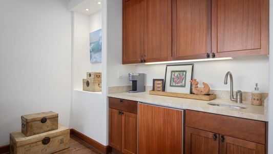 Convenient wet bar in the family den with charming artwork and essentials.