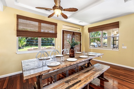 Cozy breakfast nook with seating for eight, bathed in natural light from surrounding windows.