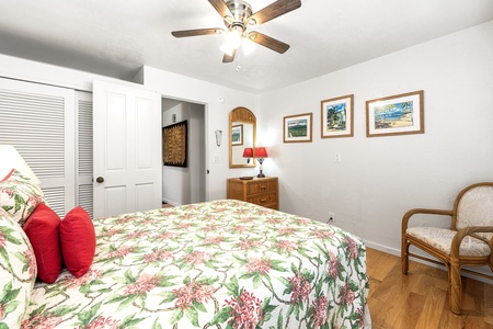 Sink into your tropical oasis with cheerful floral bedding, gentle ceiling fan breezes, and charming artwork creating the perfect island escape.