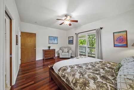 Spacious bedroom with natural light and hardwood floors.