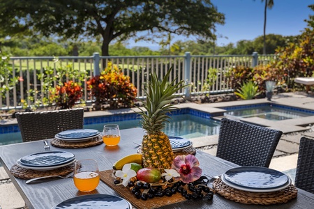 Start your mornings with tropical fruit and Kona coffee overlooking the pool and golf course in this private oasis.
