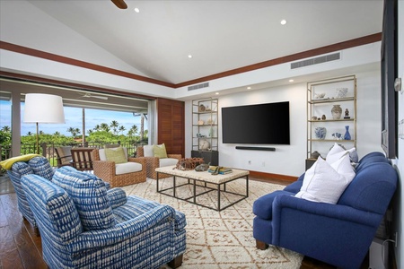 The living room offers a comfortable space with ample seating and a large TV, perfect for unwinding with loved ones.