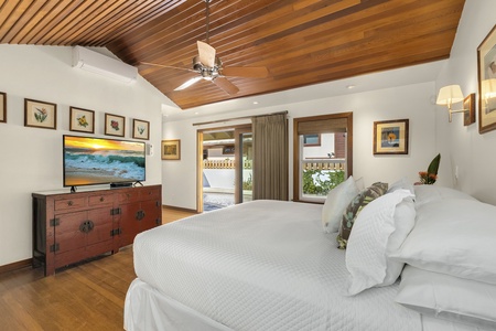 Elegant primary suite with direct access to the pool and lush backyard, combining comfort and convenience.