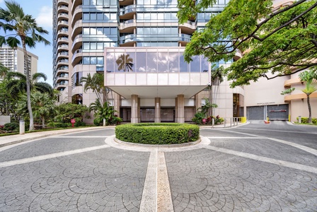 Arrive at Waikiki Landmark with secure entry and tropical landscaping throughout.