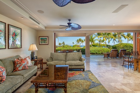 Lounge in the living area with pocketing sliding glass doors that opens to the expansive lanai for seamless indoor-outdoor living.