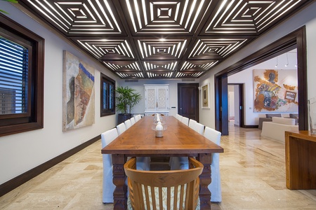 Dine in style in this dining area featuring a long table for fourteen.