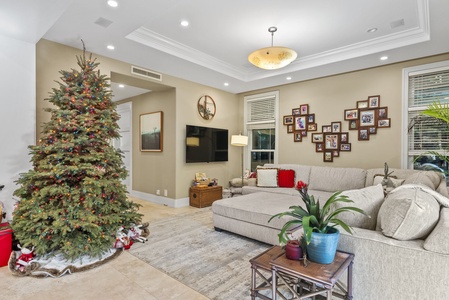 Stylish seating area with a festive Christmas tree centerpiece.