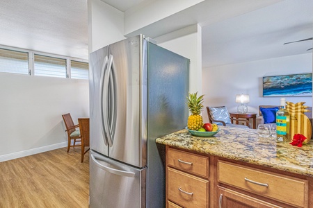 A spacious fridge and granite counters at Royal Kahana 213 offer plenty of space for cooking and storage.