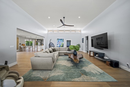 Open-concept living room with Smart TV, ceiling fan, and warm wood tones—ideal for relaxing after a day at the beach.