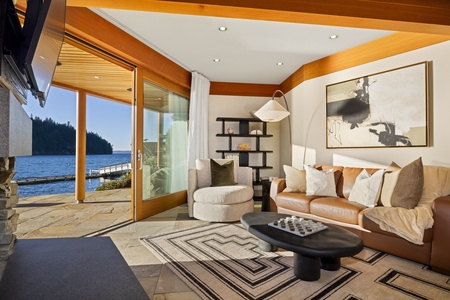 Elegant living space with floor-to-ceiling windows and waterfront views.