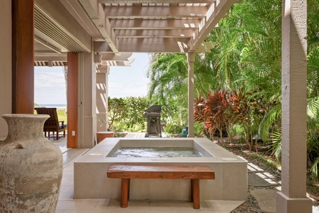 Relax in the outdoor spa with garden views.