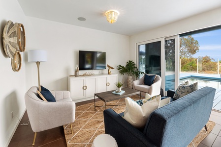 Family room with TV and wall opening to the great outdoors