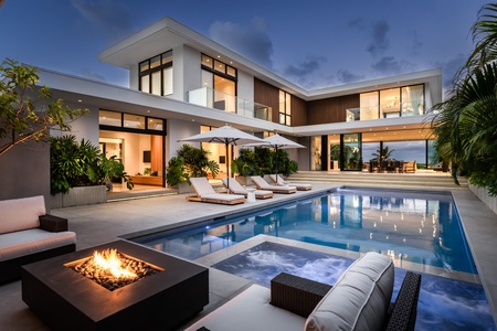 Sink into the evening as your private pool terrace glows beneath the Kailua sky.