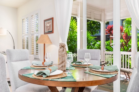 Tranquil lanai retreat surrounded by lush tropical foliage.