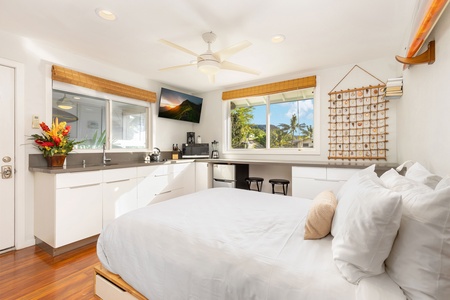 The studio features a kitchenette with a sink, mini fridge, and multi-use counter space for added flexibility.