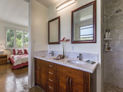 Double sinks and marble counters in first-floor primary bath.