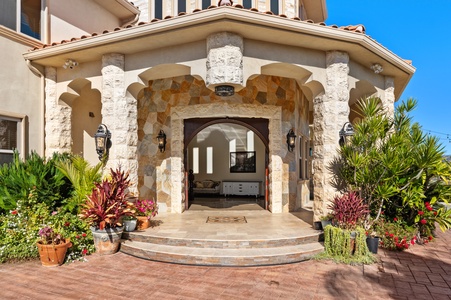 Stone archwork and a carved portico set the tone before the front door.