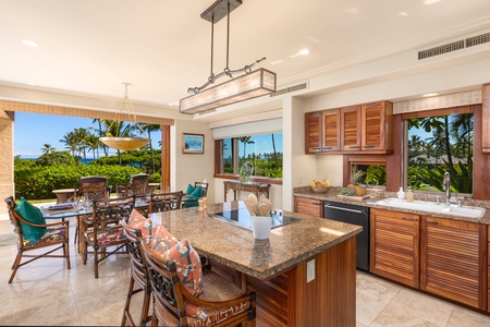 Gourmet kitchen with granite countertops, Koa cabinetry, and a central prep island.