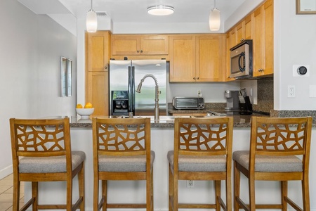 The kitchen area has ample counter spaces, designed to create hearty meals a breeze
