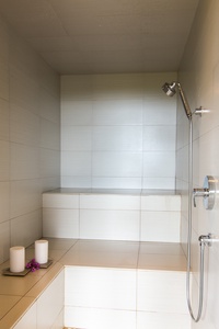Relax and rejuvenate in the modern steam room, designed for a spa-like experience at home.
