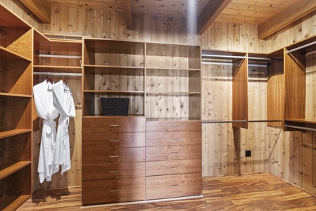 Spacious walk-in closet with ample storage and rustic wood accents.