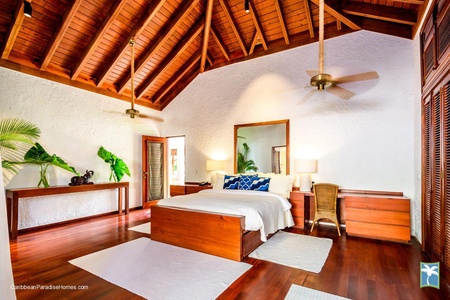 The guest bedroom with high ceilings and stylish decor.