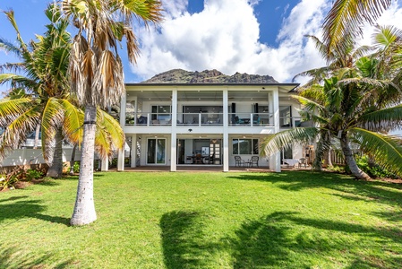 Spacious upper lanai with plush seating and panoramic coastal views.