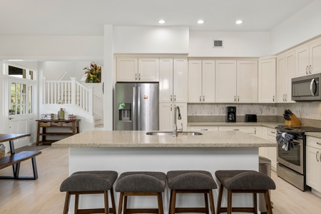 The kitchen has spacious island and bar stools, ideal for casual dining and entertaining..