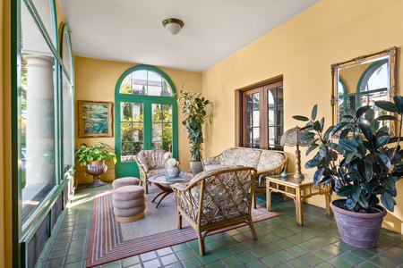 Enter the home through the sunroom, a second living area providing a bright and airy space to relax and unwind.