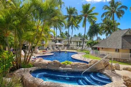 Dive into paradise at Kai Lani 14B with a resort-style pool surrounded by lush tropical greenery.