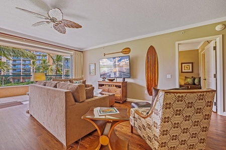 The living area has comfortable seating and direct access to the lanai for seamless indoor-outdoor living.