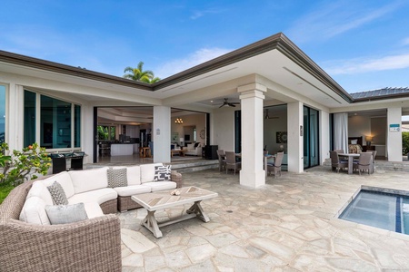 Spacious covered lanai with comfortable seating overlooking the pool terrace.