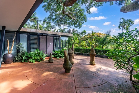 A tranquil outdoor lanai surrounded by lush tropical greenery for ultimate relaxation.