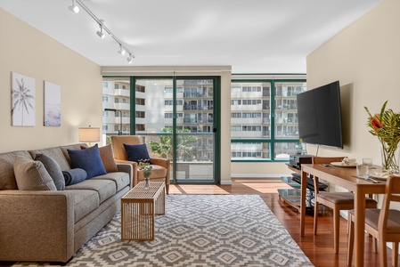 Gather in the sunlit living area with comfortable seating and breezy city views.