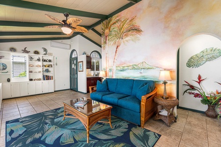 Featuring a queen sleeper sofa, ceiling fan, and colorful island-inspired décor for an authentic Hawaiian vibe.